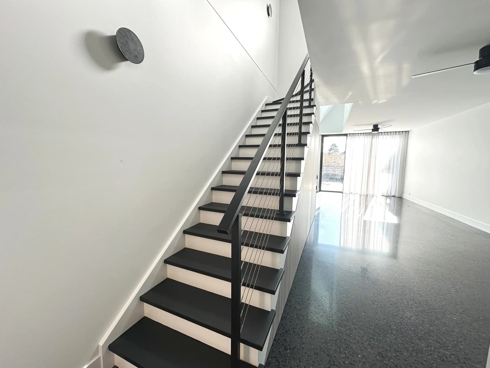 Finished staircase with crisp white balustrade and clean lines — the completed Tricoat standard